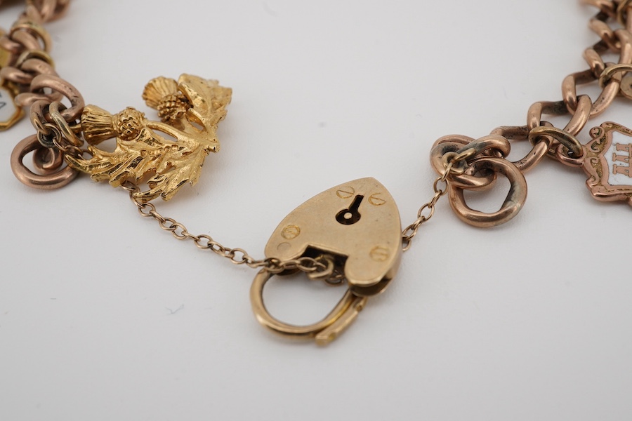 A 9ct gold charm bracelet, with heart shaped clasp, hung with fourteen assorted charms including five 9ct, two 14k and two 18k and five unmarked, gross weight 39 grams. Condition - fair